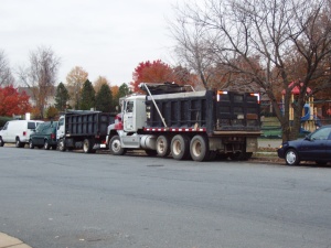 Two Dump Trucks on Daniels Ave behind ACCA and across from the American Legion.